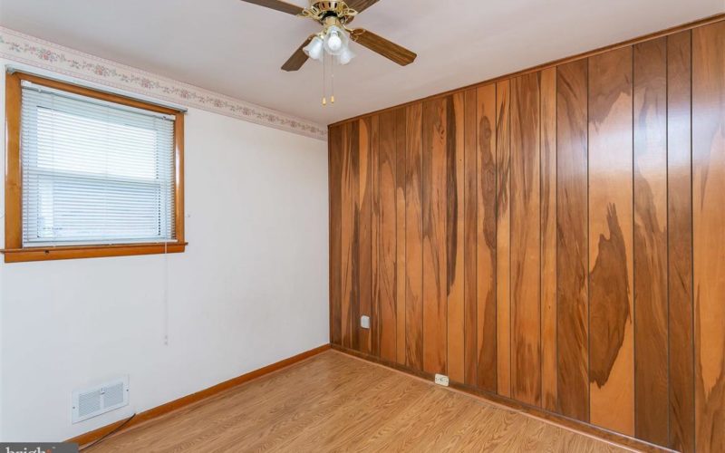 719 50th Street, bedroom ceiling fan and wood panel wall