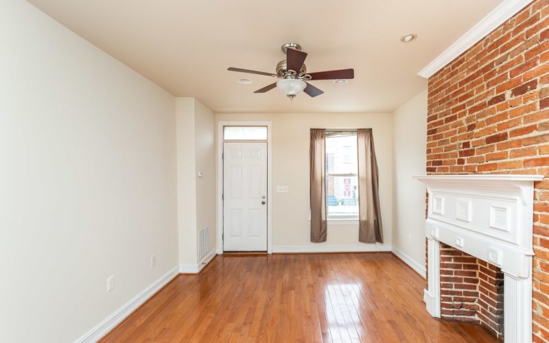 2012 Gough Street, living room with ceiling fan and exposed brick