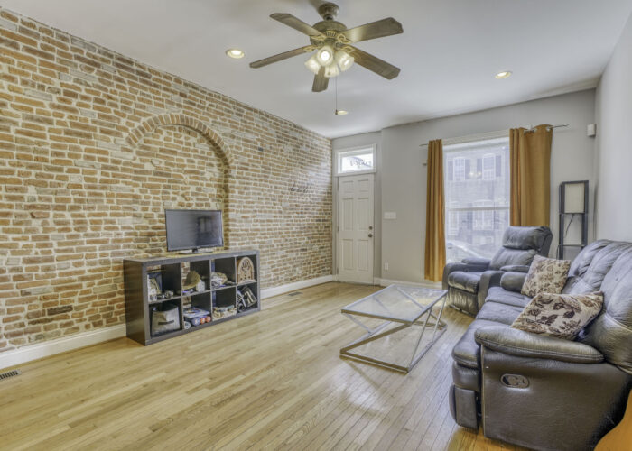 3304 E Baltimore St., living room with exposed brick