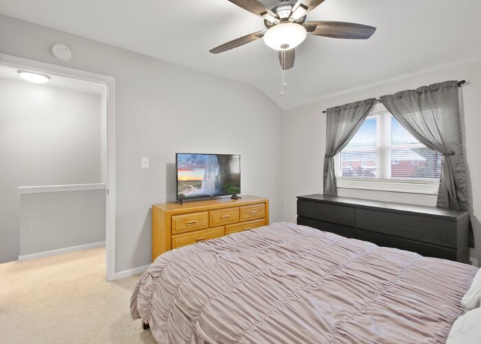 8054 Wallace Road, first bedroom with ceiling fan