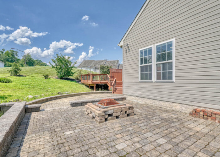 4900 Villa Point, stone area with fire pit and looking to the greenery