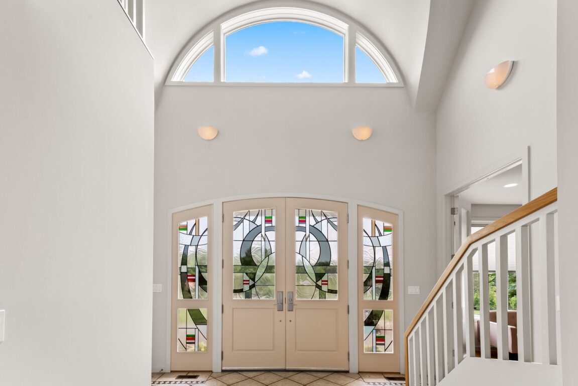 11324 Cedar Lane, entryway with front door, high windows and stained glass.