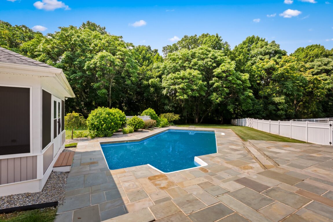 11324 Cedar Lane, looking at the pool, paving stones and pool house.