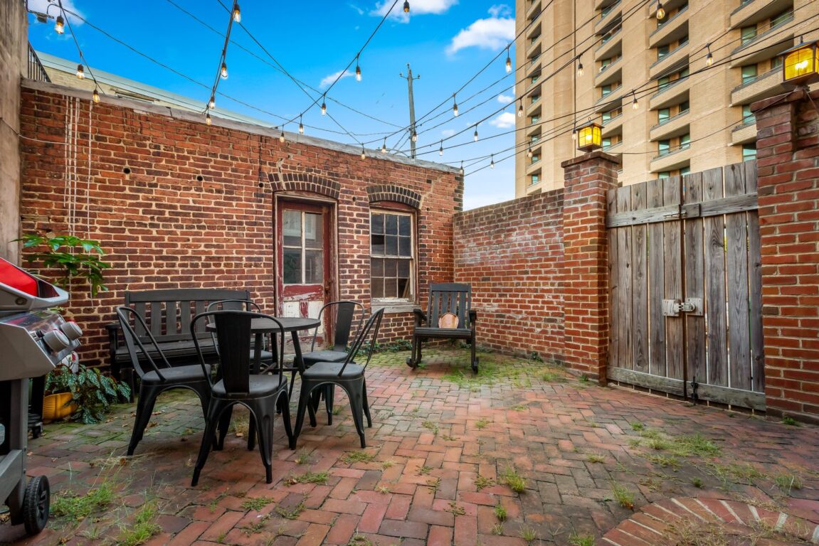 15 W Chase St, outdoor patio showing large door to alley.