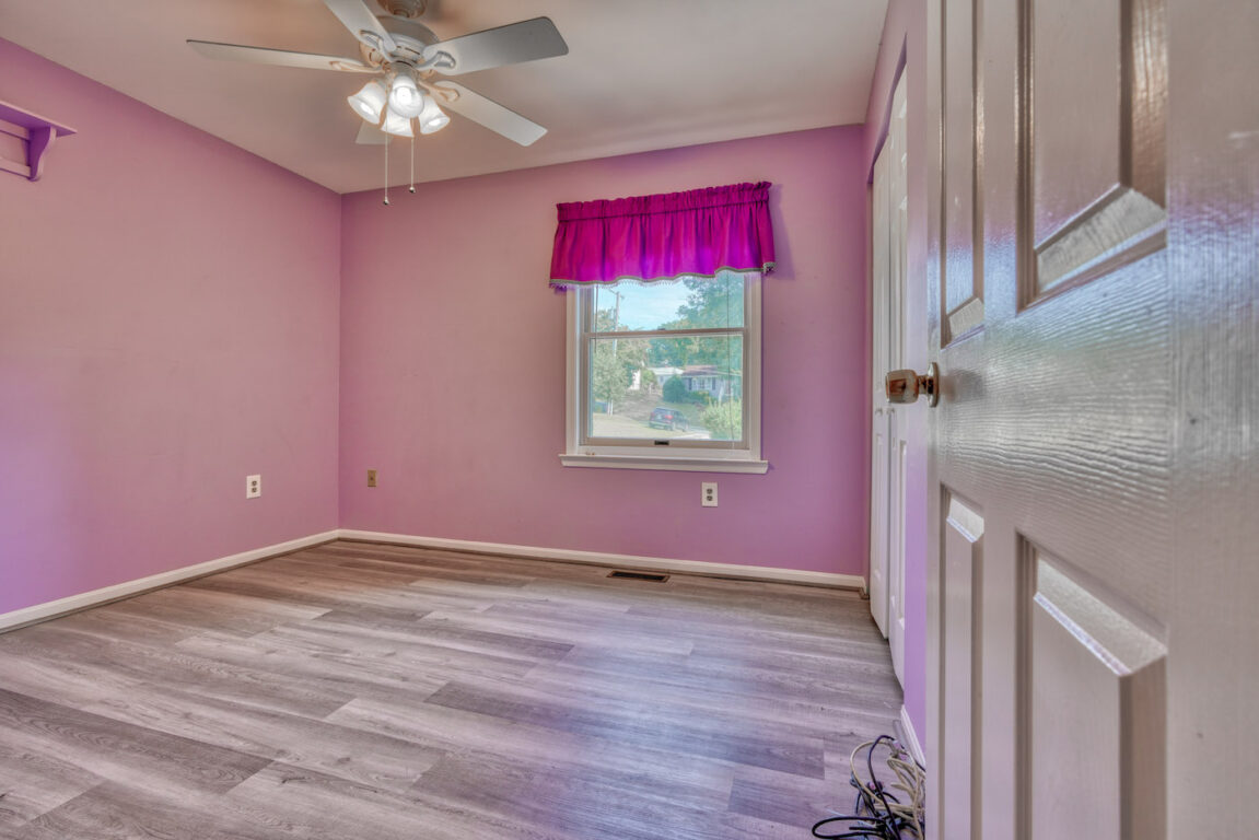 7512 Riddle Avenue, 2nd bedroom with window and pink curtain.