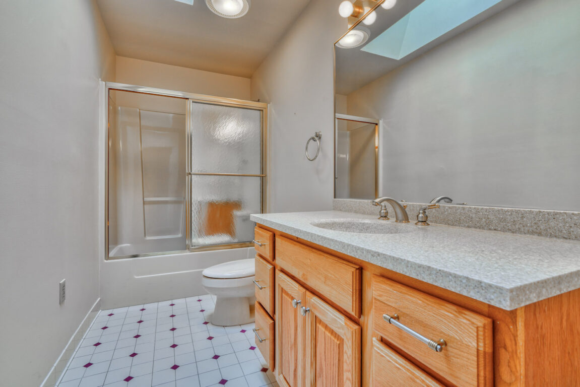 7512 Riddle Avenue, bathroom with frosted glass shower doors.