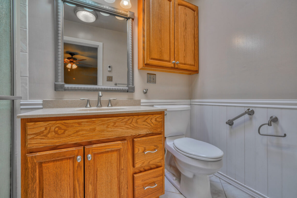 7512 Riddle Avenue, bathroom with wood vanity.