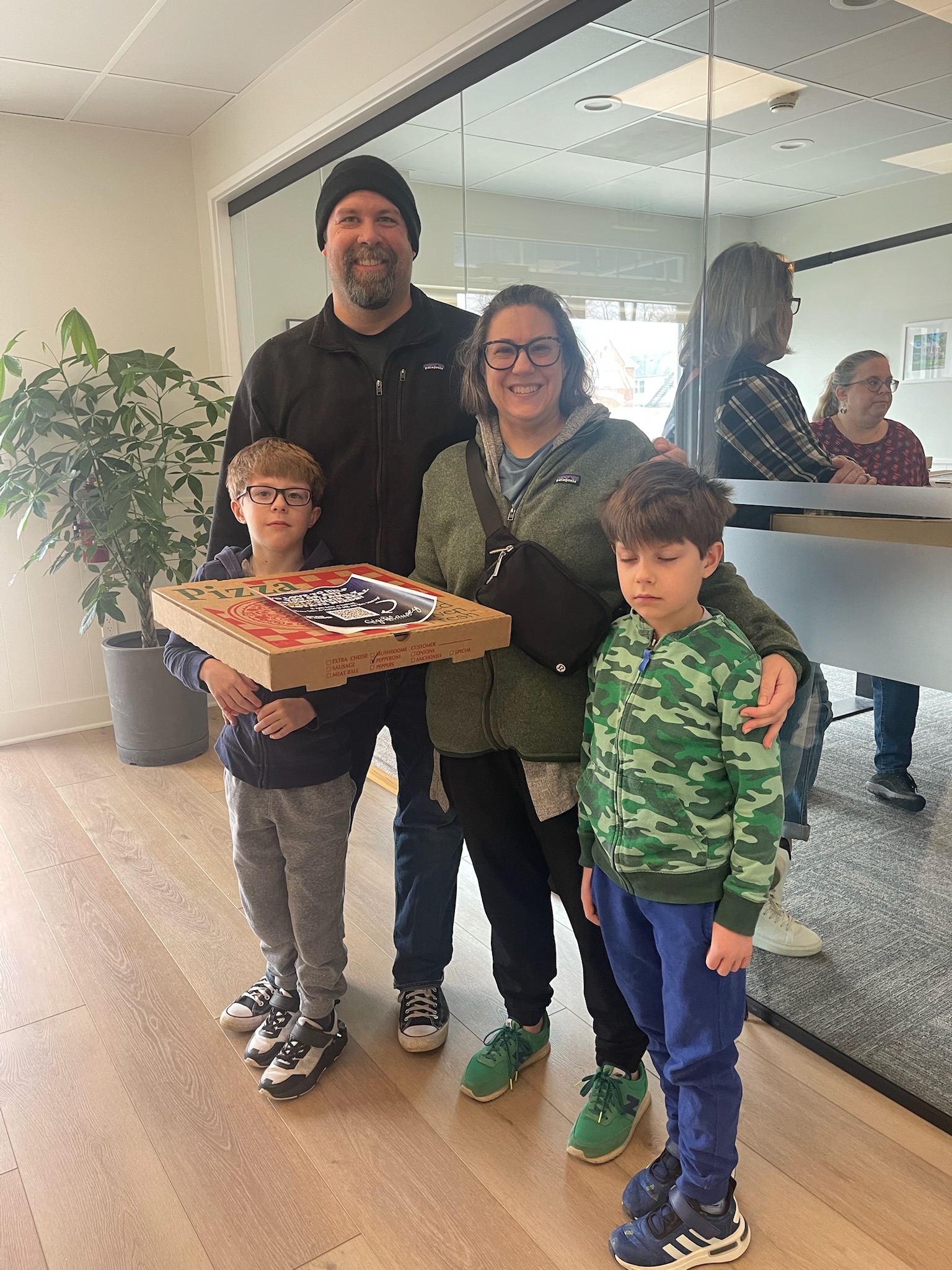 family of four picks up their Super Bowl Pizza