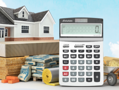 A house, stack of money and calculator you will need for the 5 home renovation projects in the story.