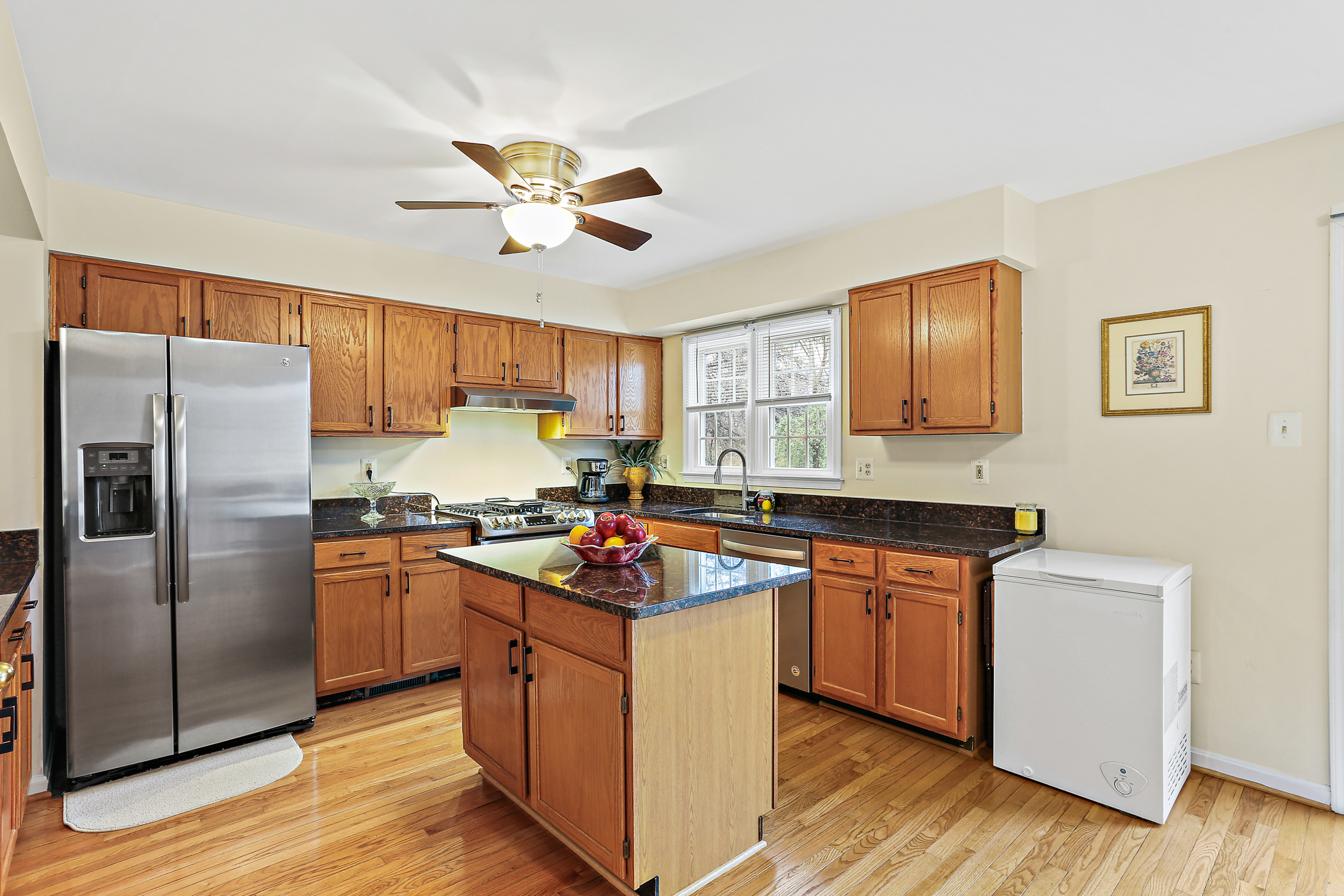 6203 Knolls Ct, kitchen with island, stainless appliances and wooden cabinets.