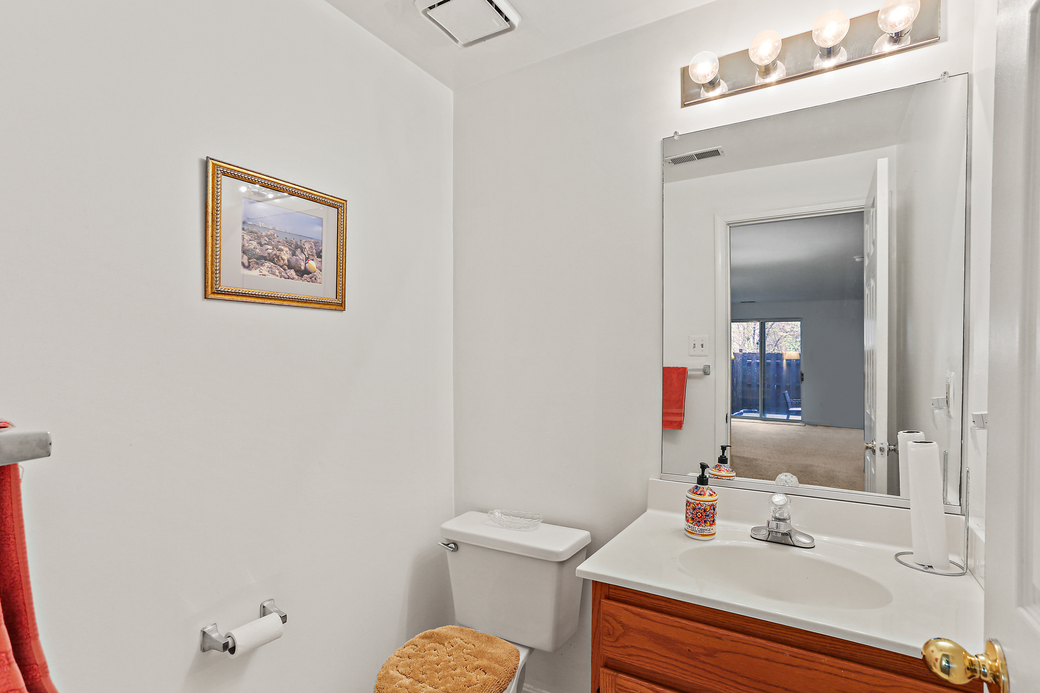 6203 Knolls Ct, powder room with reflection of basement in the mirror.